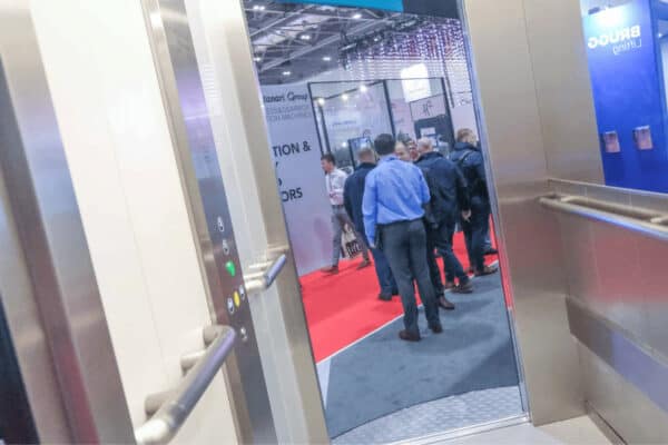 A group of people standing in an elevator